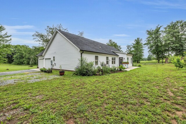 8012 Mcdonald Cemetery Rd, Ooltewah, TN 37363 - view of home's exterior featuring driveway, a lawn, and an attached garage
