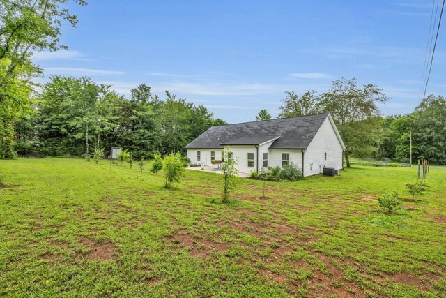 8012 Mcdonald Cemetery Rd, Ooltewah, TN 37363 - back of property featuring a yard, central AC, and a patio
