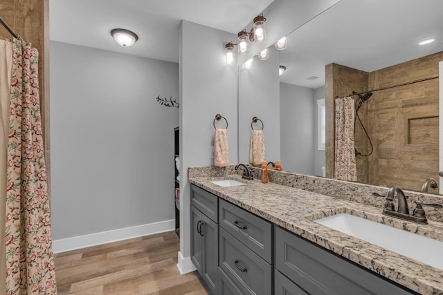 8012 Mcdonald Cemetery Rd, Ooltewah, TN 37363 - full bath with double vanity, wood finished floors, a tile shower, and baseboards