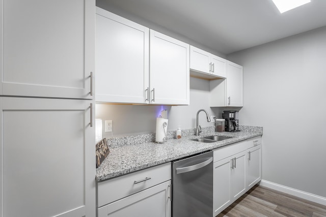 900 Mountain Creek Rd Unit 300, Chattanooga, TN 37405 - kitchen featuring dishwasher, a sink, white cabinetry, wood finished floors, and light stone counters