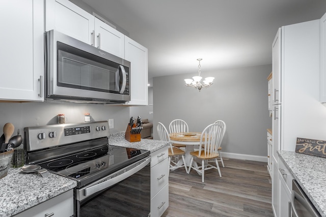 900 Mountain Creek Rd Unit 300, Chattanooga, TN 37405 - kitchen with stainless steel appliances, a chandelier, white cabinetry, light wood-type flooring, and baseboards