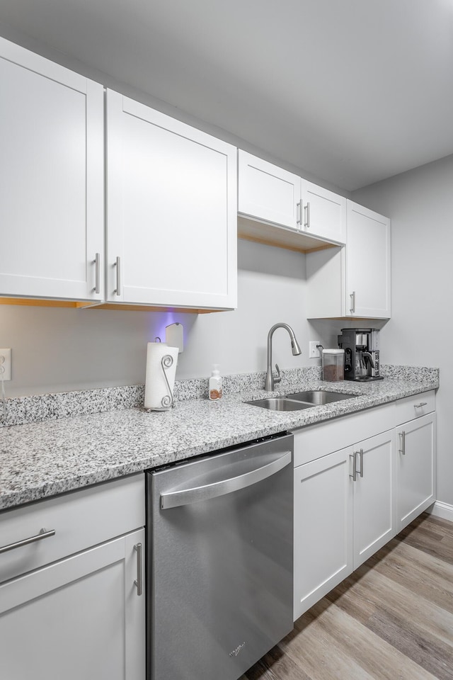 900 Mountain Creek Rd Unit 300, Chattanooga, TN 37405 - kitchen with dishwasher, a sink, white cabinets, light wood-type flooring, and light stone countertops