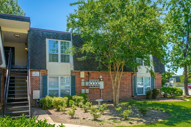 900 Mountain Creek Rd Unit 300, Chattanooga, TN 37405 - view of front of home with brick siding, a shingled roof, and stairway