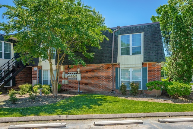 900 Mountain Creek Rd Unit 300, Chattanooga, TN 37405 - view of front of house featuring brick siding, uncovered parking, a shingled roof, a front yard, and mansard roof