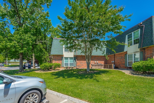 900 Mountain Creek Rd Unit 300, Chattanooga, TN 37405 - view of front of home with brick siding, a shingled roof, a front yard, and mansard roof