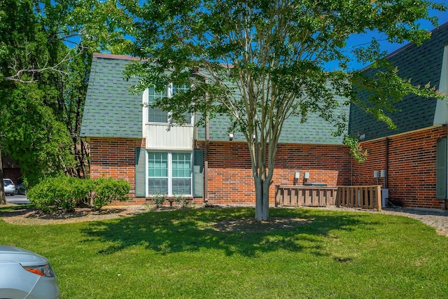 900 Mountain Creek Rd Unit 300, Chattanooga, TN 37405 - back of house featuring brick siding, roof with shingles, and a lawn