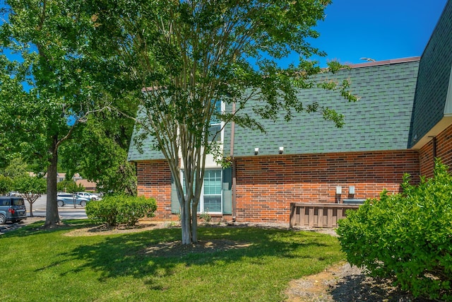 900 Mountain Creek Rd Unit 300, Chattanooga, TN 37405 - view of side of property featuring brick siding, a yard, and a shingled roof