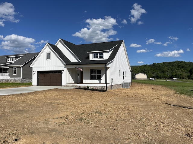 4958 Old State Highway 28, Dunlap, TN 37327 - modern farmhouse style home featuring a porch, central air condition unit, board and batten siding, and concrete driveway