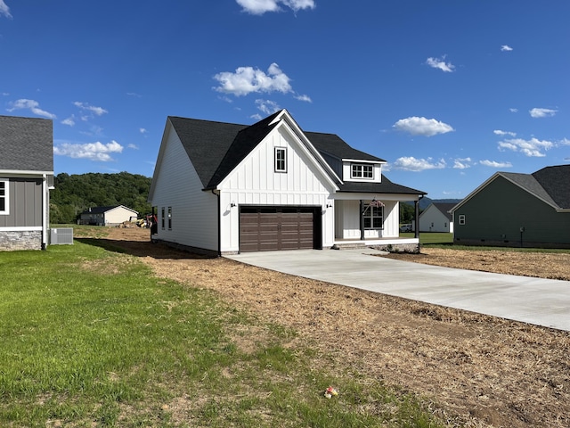 4958 Old State Highway 28, Dunlap, TN 37327 - modern inspired farmhouse featuring board and batten siding, covered porch, concrete driveway, a front lawn, and central AC unit