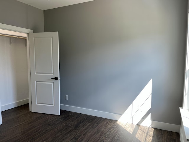 4958 Old State Highway 28, Dunlap, TN 37327 - unfurnished bedroom with dark wood finished floors, baseboards, and a closet
