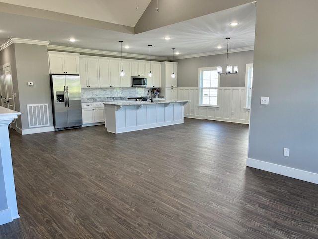 4958 Old State Highway 28, Dunlap, TN 37327 - kitchen featuring appliances with stainless steel finishes, ornamental molding, an island with sink, white cabinetry, and dark wood-type flooring