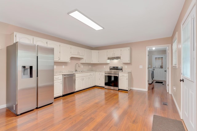 347 Highland Dr, Dunlap, TN 37327 - kitchen with stainless steel appliances, white cabinetry, light wood-style floors, under cabinet range hood, and baseboards