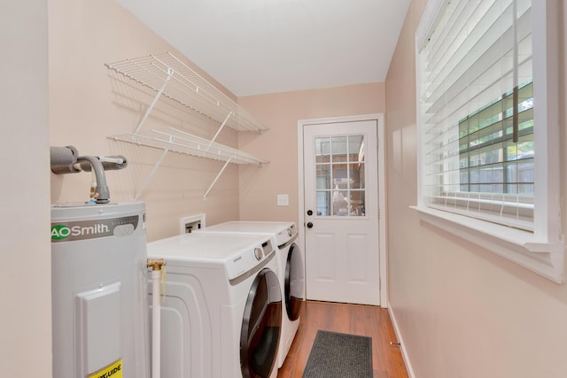 347 Highland Dr, Dunlap, TN 37327 - laundry area featuring electric water heater, washer and clothes dryer, light wood finished floors, and baseboards