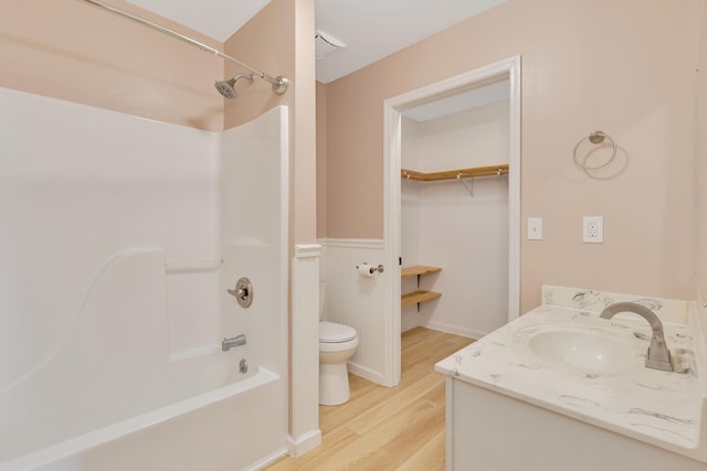 347 Highland Dr, Dunlap, TN 37327 - full bath with toilet, wood finished floors, vanity, bathing tub / shower combination, and a wainscoted wall
