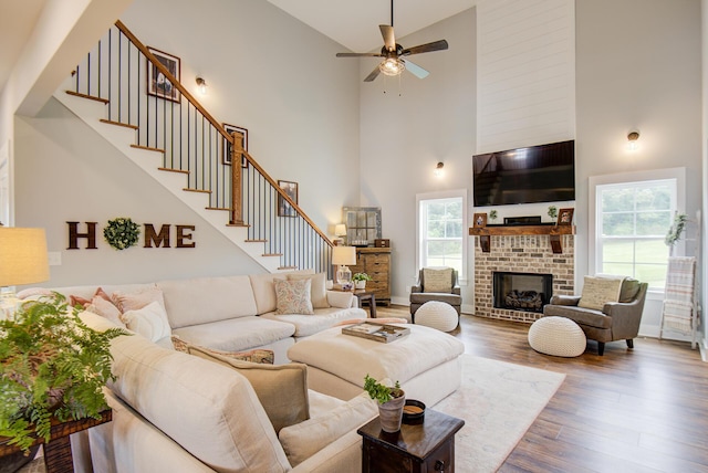 9117 Sir Hudson Ct, Harrison, TN 37341 - living area with a high ceiling, wood finished floors, ceiling fan, stairway, and a fireplace