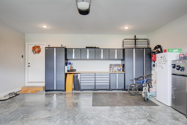 9117 Sir Hudson Ct, Harrison, TN 37341 - garage featuring recessed lighting, a garage door opener, and freestanding refrigerator