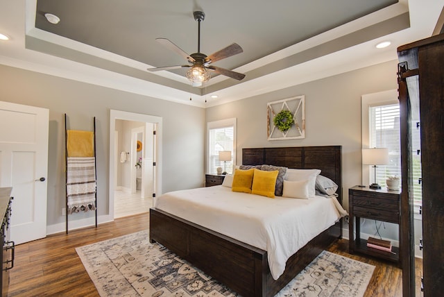 9117 Sir Hudson Ct, Harrison, TN 37341 - bedroom with a tray ceiling, dark wood finished floors, recessed lighting, baseboards, and ensuite bathroom