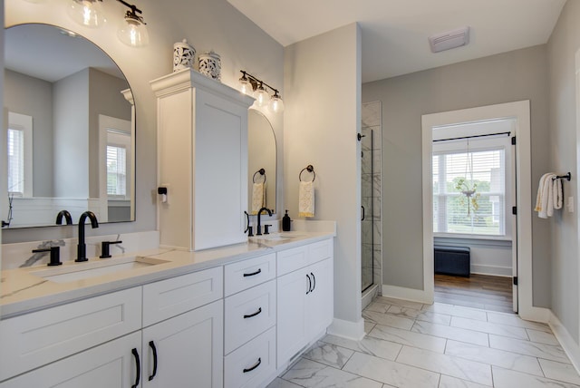 9117 Sir Hudson Ct, Harrison, TN 37341 - bathroom featuring marble look tiles, a stall shower, double vanity, and baseboards