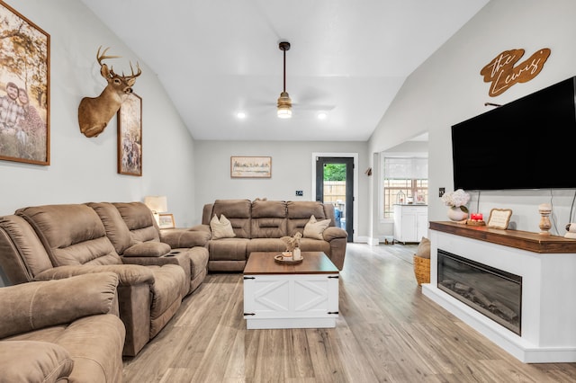 329 Windsong Dr, Lafayette, GA 30728 - living room featuring lofted ceiling, ceiling fan, light wood-style floors, and a glass covered fireplace