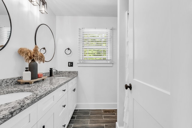 329 Windsong Dr, Lafayette, GA 30728 - bathroom featuring double vanity, baseboards, and wood tiled floors
