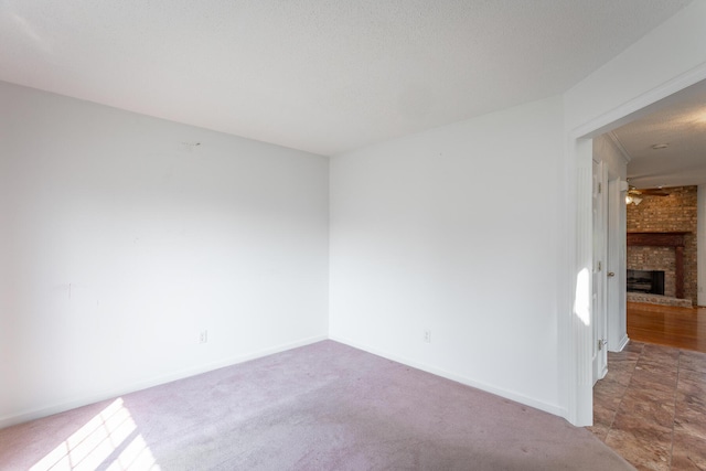 8275 Stillwater Cir, Ooltewah, TN 37363 - spare room featuring a fireplace, baseboards, and carpet flooring