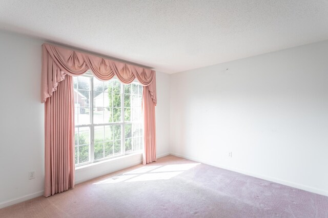 8275 Stillwater Cir, Ooltewah, TN 37363 - spare room featuring carpet flooring, a textured ceiling, and baseboards