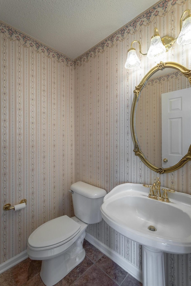 8275 Stillwater Cir, Ooltewah, TN 37363 - half bathroom featuring baseboards, toilet, a textured ceiling, a sink, and tile patterned flooring