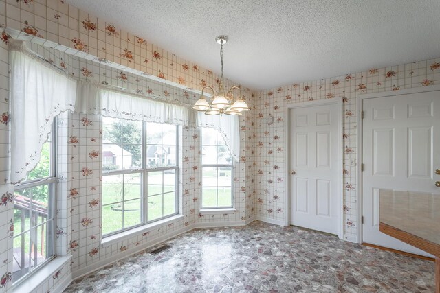 8275 Stillwater Cir, Ooltewah, TN 37363 - unfurnished dining area with baseboards, a textured ceiling, tile patterned floors, and wallpapered walls
