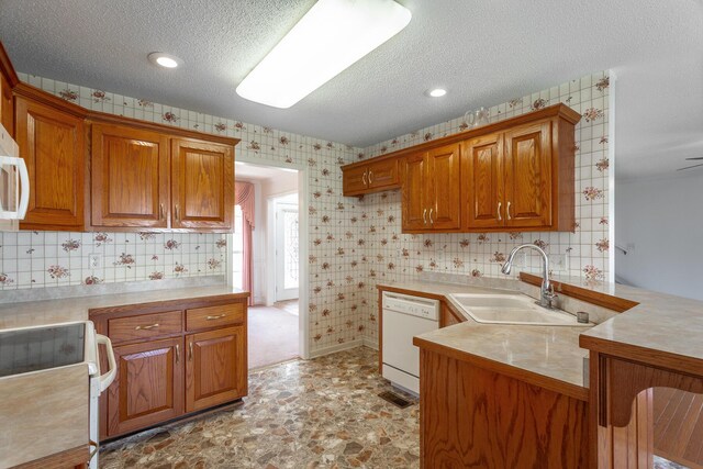 8275 Stillwater Cir, Ooltewah, TN 37363 - kitchen featuring white appliances, a sink, brown cabinets, light countertops, and a textured ceiling