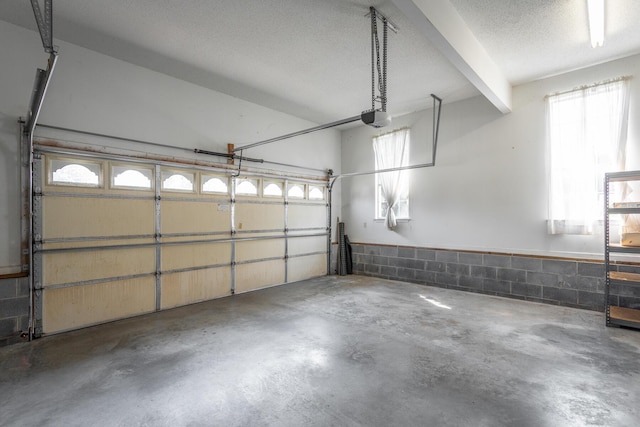 8275 Stillwater Cir, Ooltewah, TN 37363 - garage featuring a garage door opener and concrete block wall