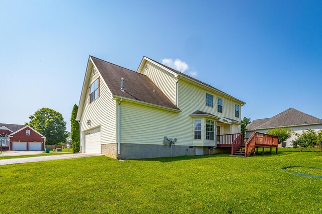 8275 Stillwater Cir, Ooltewah, TN 37363 - back of house featuring a deck, a yard, driveway, and an attached garage
