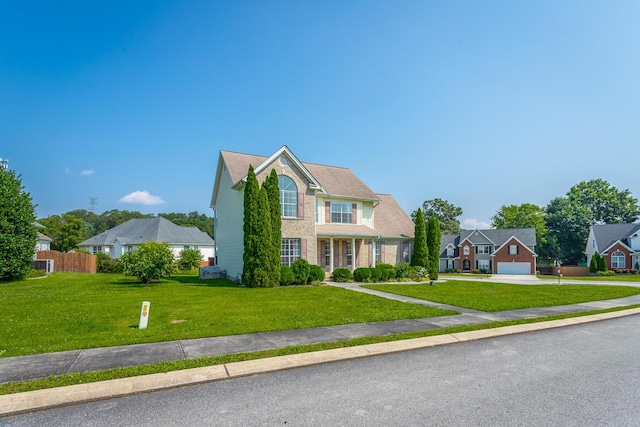 8275 Stillwater Cir, Ooltewah, TN 37363 - view of front of home featuring a garage, a front lawn, concrete driveway, and brick siding