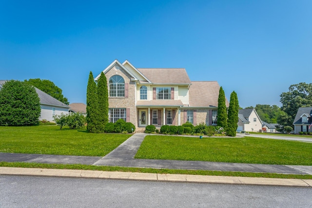8275 Stillwater Cir, Ooltewah, TN 37363 - view of front facade with a front yard and brick siding
