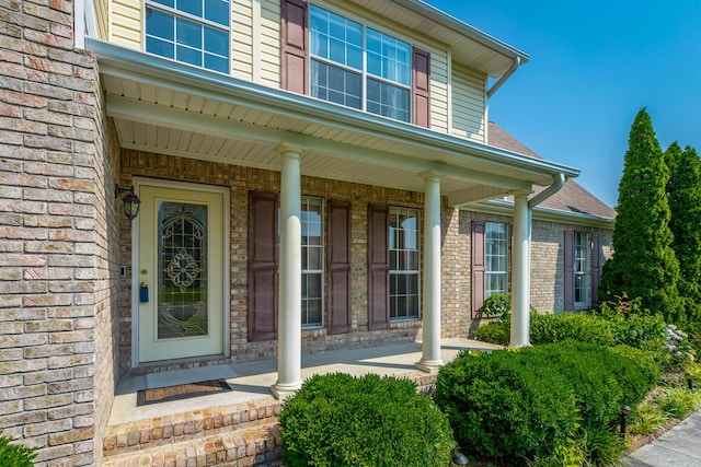 8275 Stillwater Cir, Ooltewah, TN 37363 - doorway to property with covered porch, brick siding, and a shingled roof