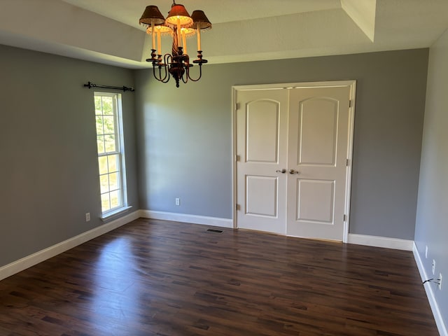 12466 Alabama Hwy, Ringgold, GA 30736 - unfurnished room with a chandelier, dark wood-style flooring, and baseboards