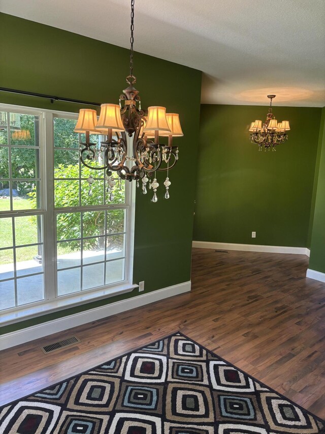 12466 Alabama Hwy, Ringgold, GA 30736 - unfurnished dining area featuring a chandelier, baseboards, dark wood-style flooring, and healthy amount of natural light