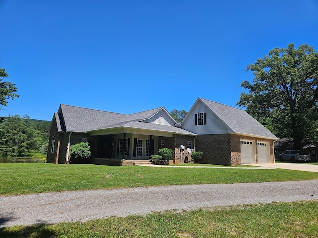 12466 Alabama Hwy, Ringgold, GA 30736 - view of front of home with a front yard, concrete driveway, brick siding, and an attached garage