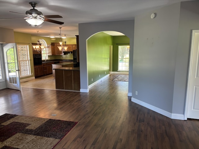 12466 Alabama Hwy, Ringgold, GA 30736 - kitchen featuring black oven, arched walkways, dark countertops, ceiling fan, and open floor plan
