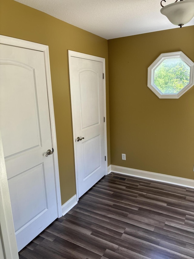 12466 Alabama Hwy, Ringgold, GA 30736 - unfurnished bedroom featuring dark wood-style flooring and baseboards