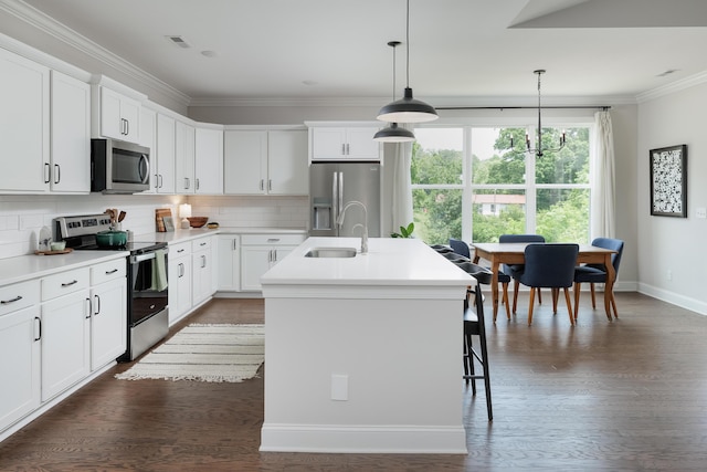 306 Stonegate Way, Soddy Daisy, TN 37379 - kitchen featuring stainless steel appliances, crown molding, an island with sink, tasteful backsplash, and dark wood-style flooring