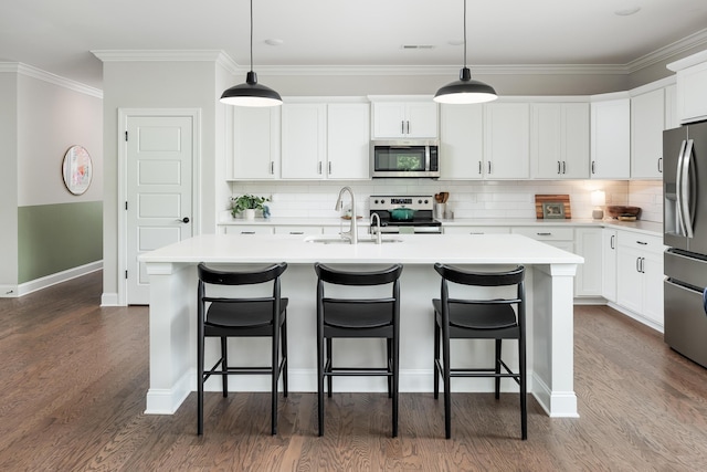 306 Stonegate Way, Soddy Daisy, TN 37379 - kitchen featuring appliances with stainless steel finishes, light countertops, tasteful backsplash, a kitchen island with sink, and ornamental molding