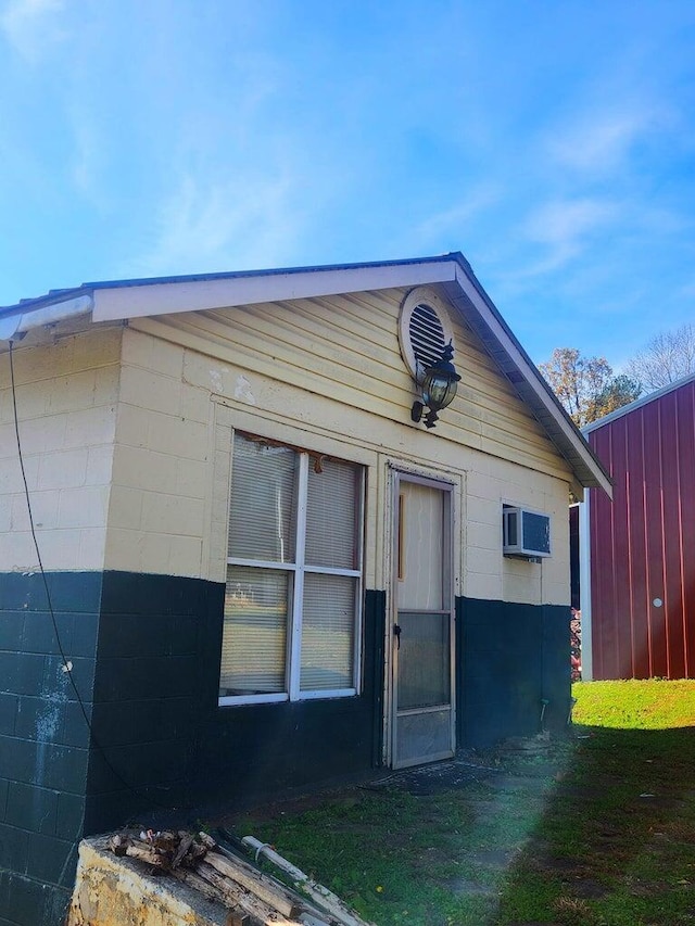 212 S Oak St, Whitwell, TN 37397 - exterior space with concrete block siding and an AC wall unit