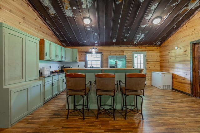 253 Hartline Rd, Trenton, GA 30752 - kitchen with green cabinets, lofted ceiling, wood walls, stainless steel fridge with ice dispenser, and dark wood-type flooring