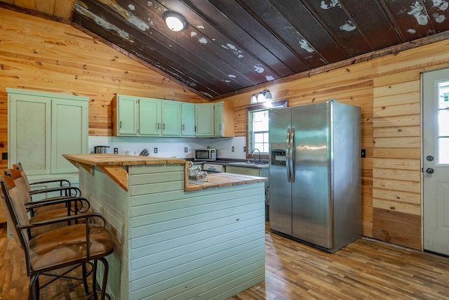 253 Hartline Rd, Trenton, GA 30752 - kitchen with appliances with stainless steel finishes, lofted ceiling, wooden walls, wooden counters, and wooden ceiling