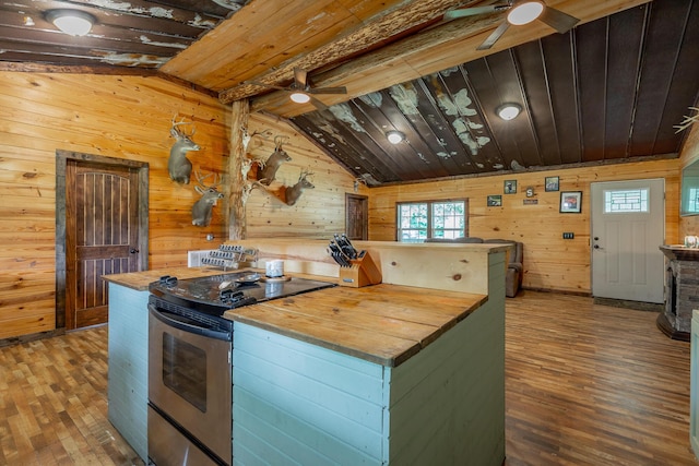 253 Hartline Rd, Trenton, GA 30752 - kitchen featuring stainless steel electric stove, ceiling fan, butcher block counters, wood walls, and wood-type flooring