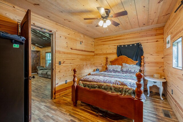 253 Hartline Rd, Trenton, GA 30752 - bedroom with wood ceiling, wood walls, wood finished floors, and a ceiling fan