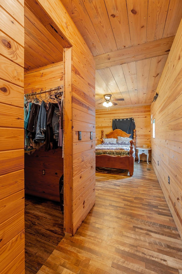 253 Hartline Rd, Trenton, GA 30752 - bedroom featuring wooden ceiling, wooden walls, wood finished floors, and a walk in closet