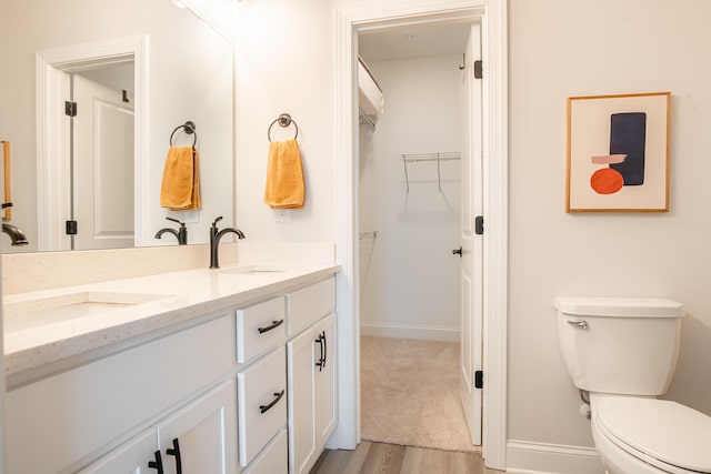 1967 Read Ave, Chattanooga, TN 37408 - full bath with wood finished floors, toilet, double vanity, and baseboards