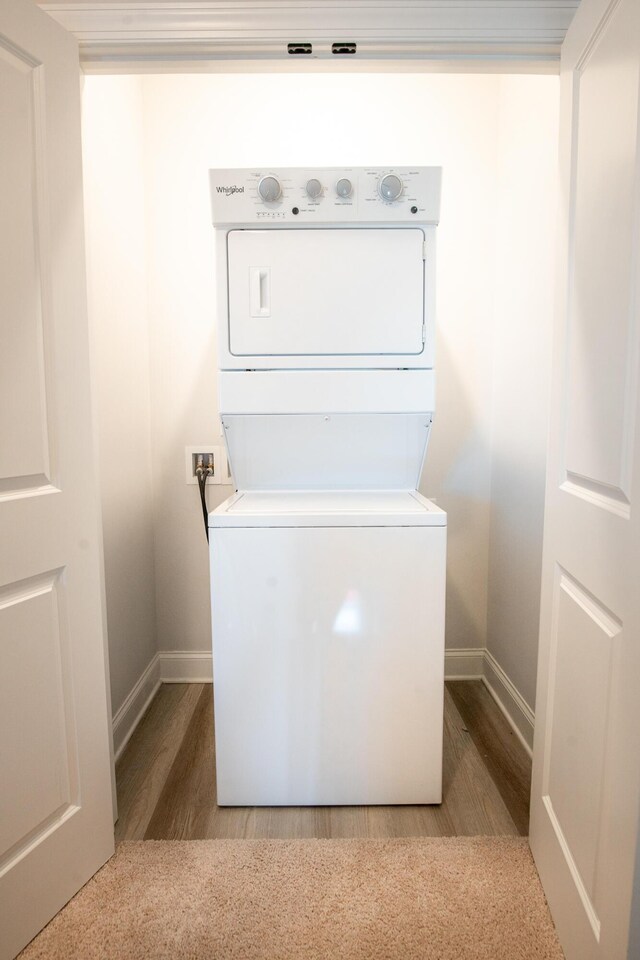 1967 Read Ave, Chattanooga, TN 37408 - laundry area featuring stacked washer and clothes dryer, baseboards, and wood finished floors