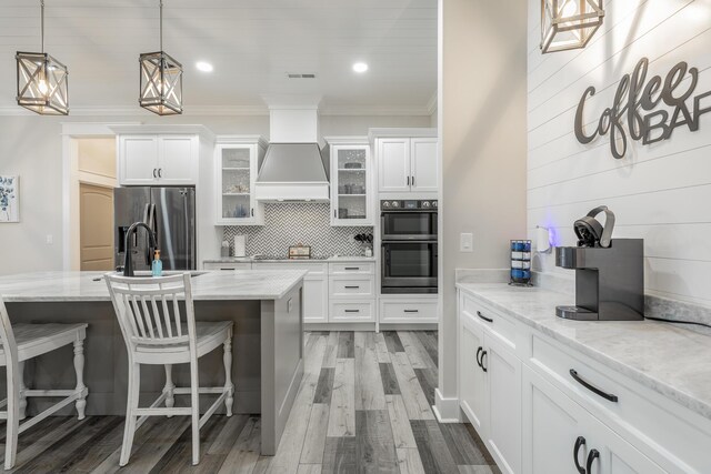 15 Breckinridge Dr, Chickamauga, GA 30707 - kitchen with black appliances, crown molding, glass insert cabinets, white cabinetry, and a breakfast bar area